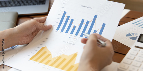 Financial businesswomen analyze the graph of the company's performance to create profits and growth, Market research reports and income statistics, Financial and Accounting concept.