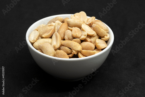 Unsalted peanuts in a white bowl