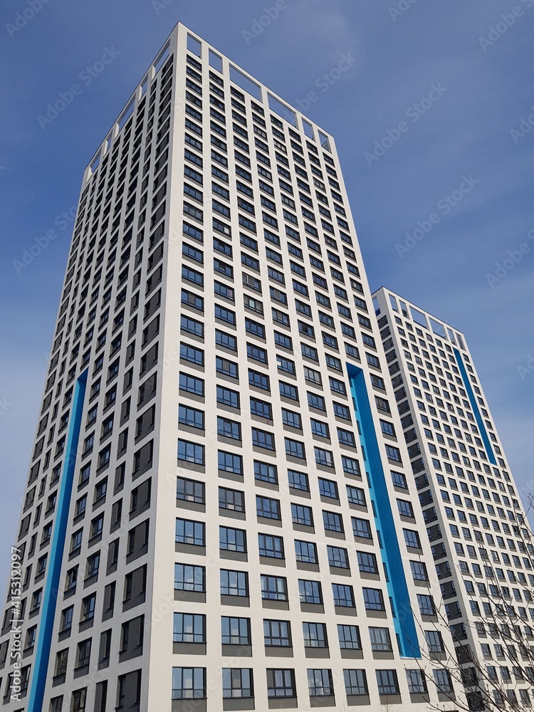 High-rise residential building against the blue sky