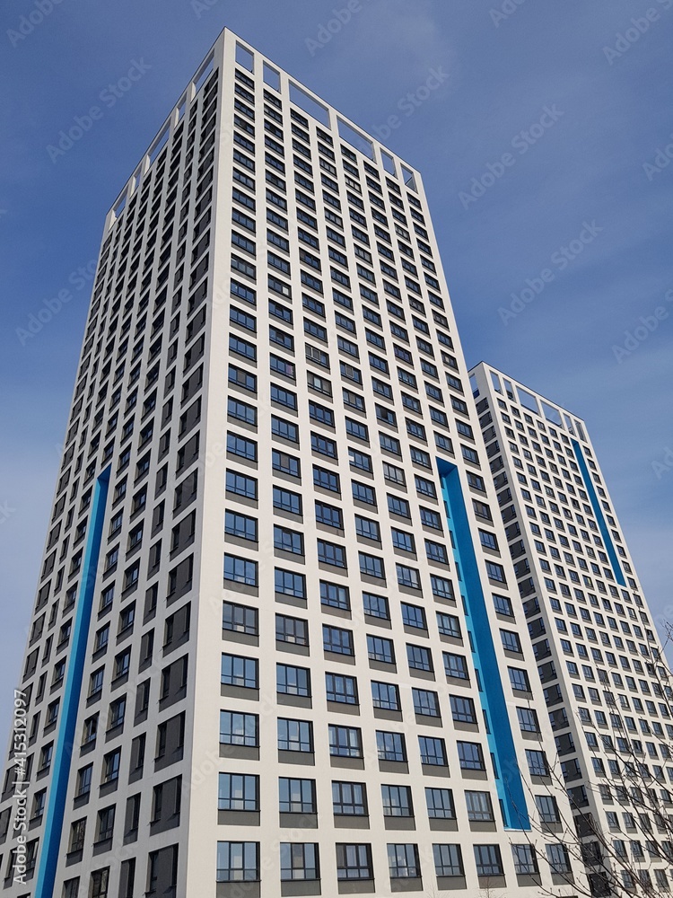 High-rise residential building against the blue sky High-rise residential building against the blue sky