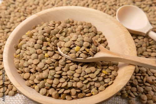 Natural organic dry brown lentils for a healthy diet. background selective focus