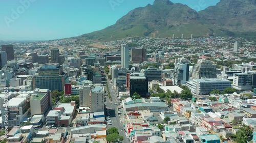 Scenic aerial wide drone shot above central Cape Town, South Africa with scenic view of harbor and downtown business area. Panoramic view of Bo-Kaap, Zonnebloem, Oranjezicht and Table Mountain. photo