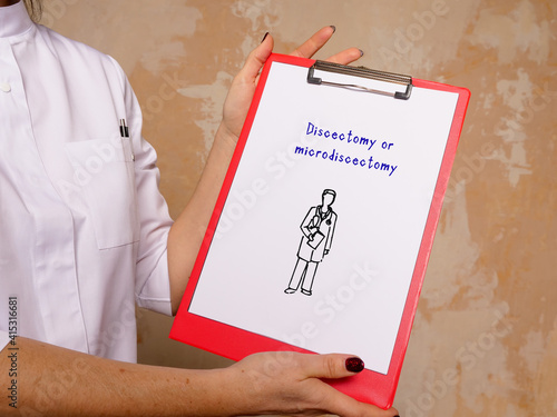 Medical concept meaning Discectomy or microdiscectomy with inscription on the piece of paper.