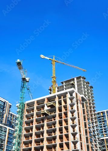 Crane and highrise construction site © Unkas Photo
