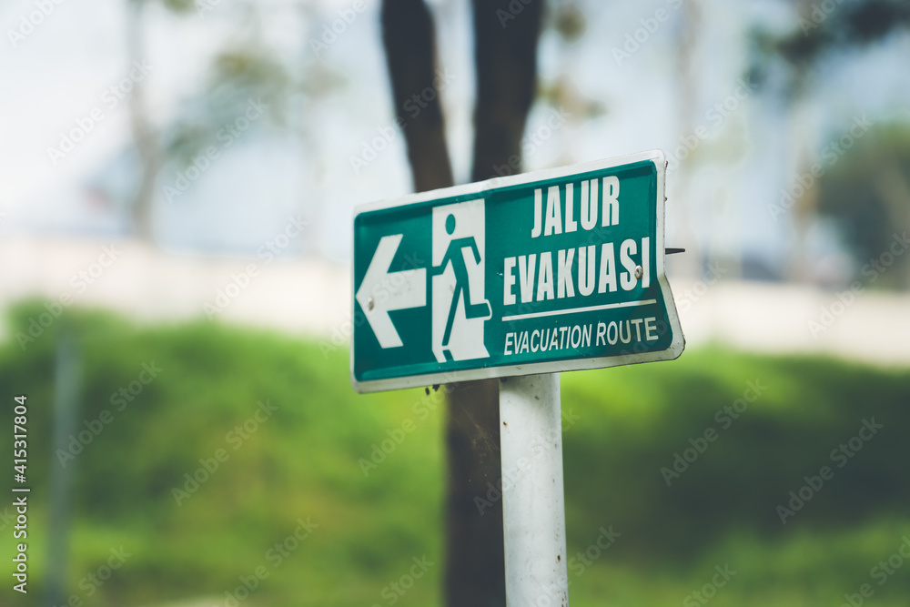 Jalur evakuasi (Evacuation Route) sign in green color on the street 