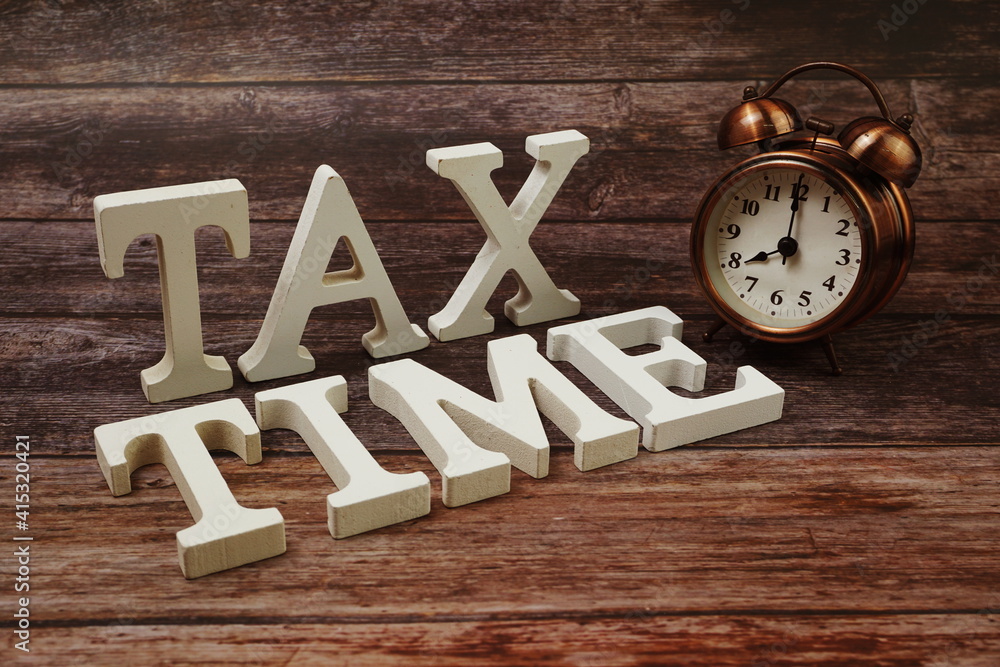 Tax Time Word alphabet letters on wooden background Tax Time Word alphabet letters on wooden background