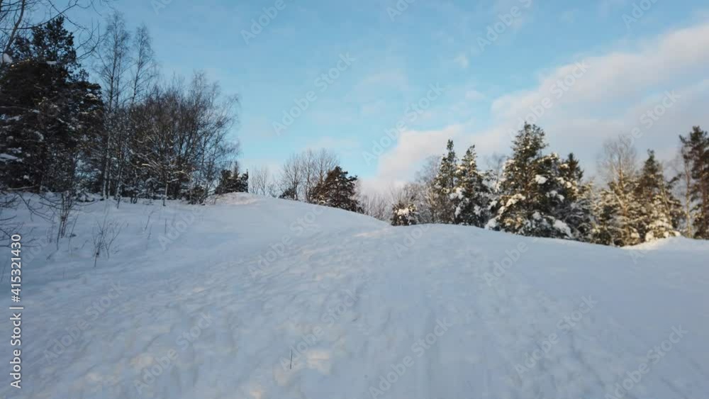 The sun has just risen in a cloudy sky over the snowy hill in Scandinavia The sun has just risen in a cloudy sky over the snowy hill in Scandinavia