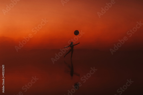 silhouette of a girl practicing a yoga exercise in a pose on the water