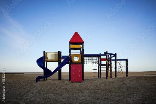 Modern and colorful play area on a Belgian beach in the early morning of a beautiful winter day