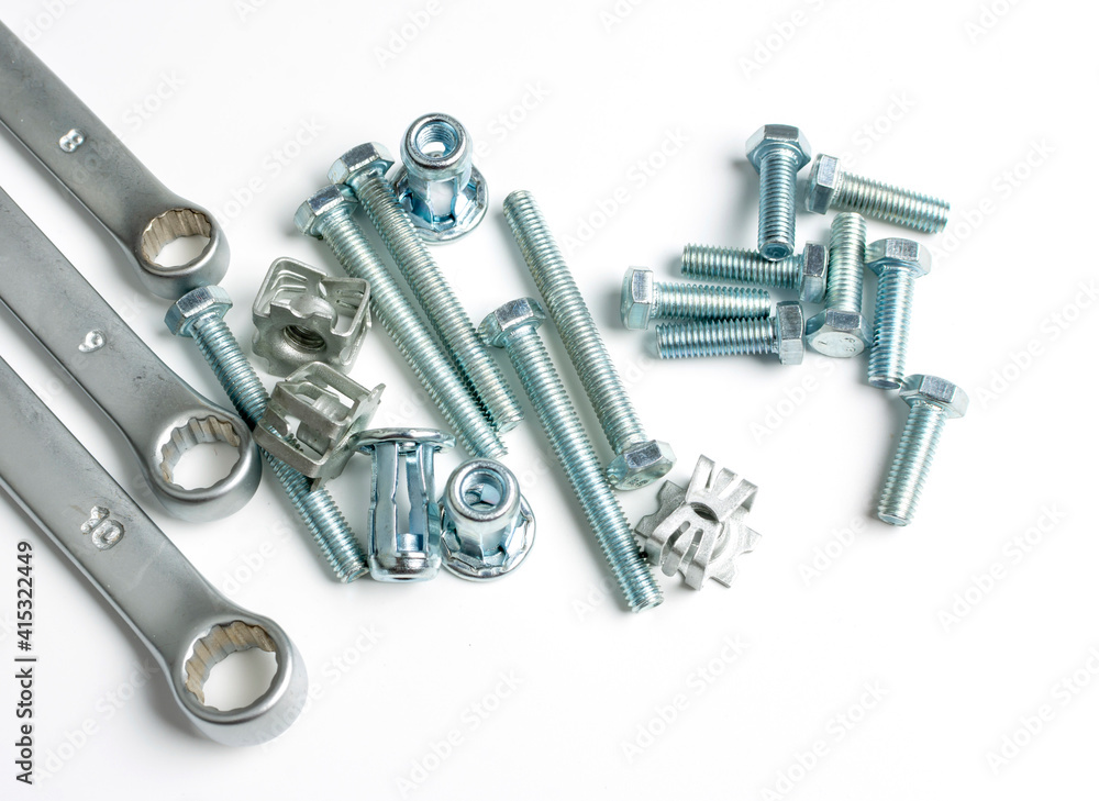 several nuts and bolts and wrenches close up several nuts and bolts and wrenches close up