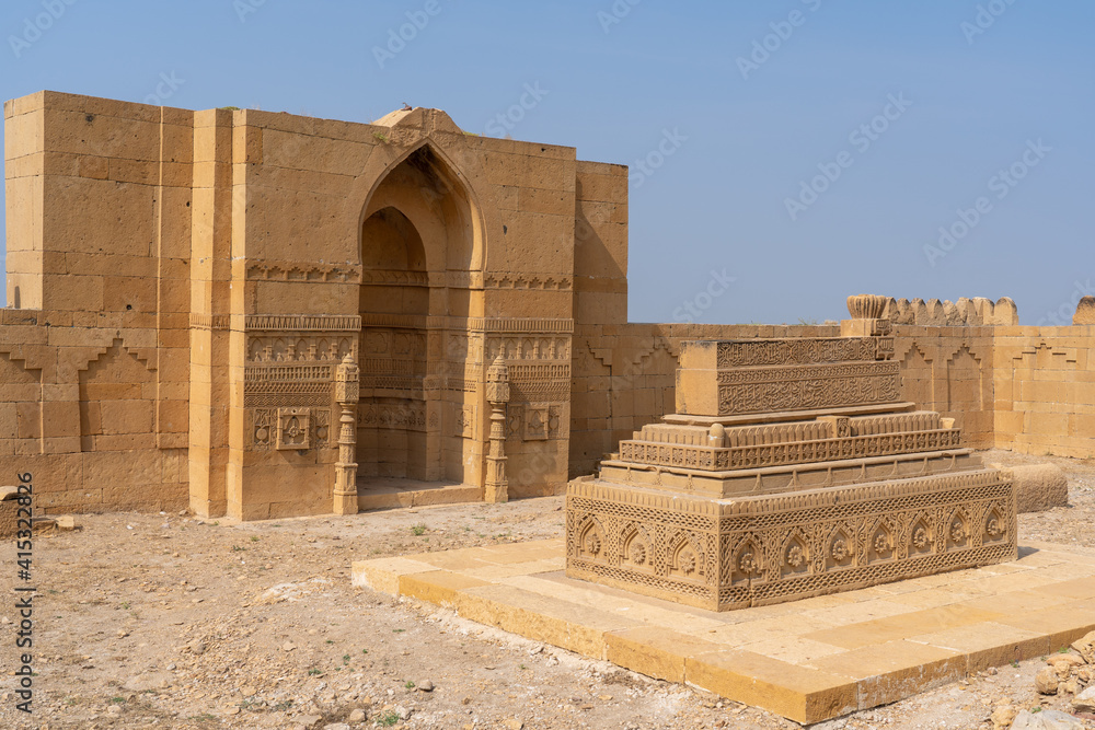 Landscape view of ancient carved stone cenotaph inside the courtyard of a royal mausoleum in UNESCO listed Makli necropolis in Thatta, Sindh, Pakistan