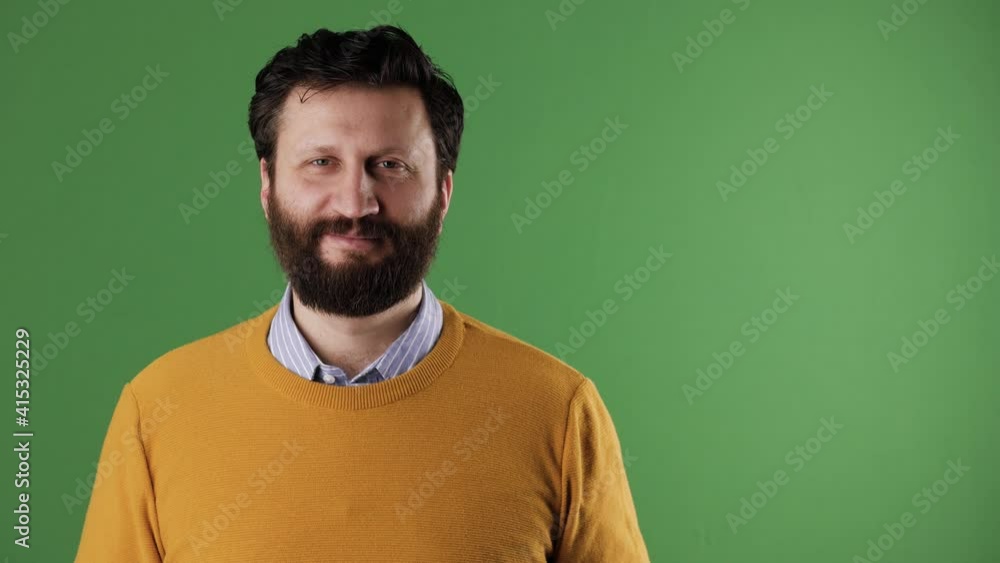 Man holding number 53 sign. Cheerful white bearded good-looking man in yellow sweater shows number fifty-three on white sheet. Chrome key, green screen, copy space Man holding number 53 sign. Cheerful white bearded good-looking man in yellow sweater shows number fifty-three on white sheet. Chrome key, green screen, copy space