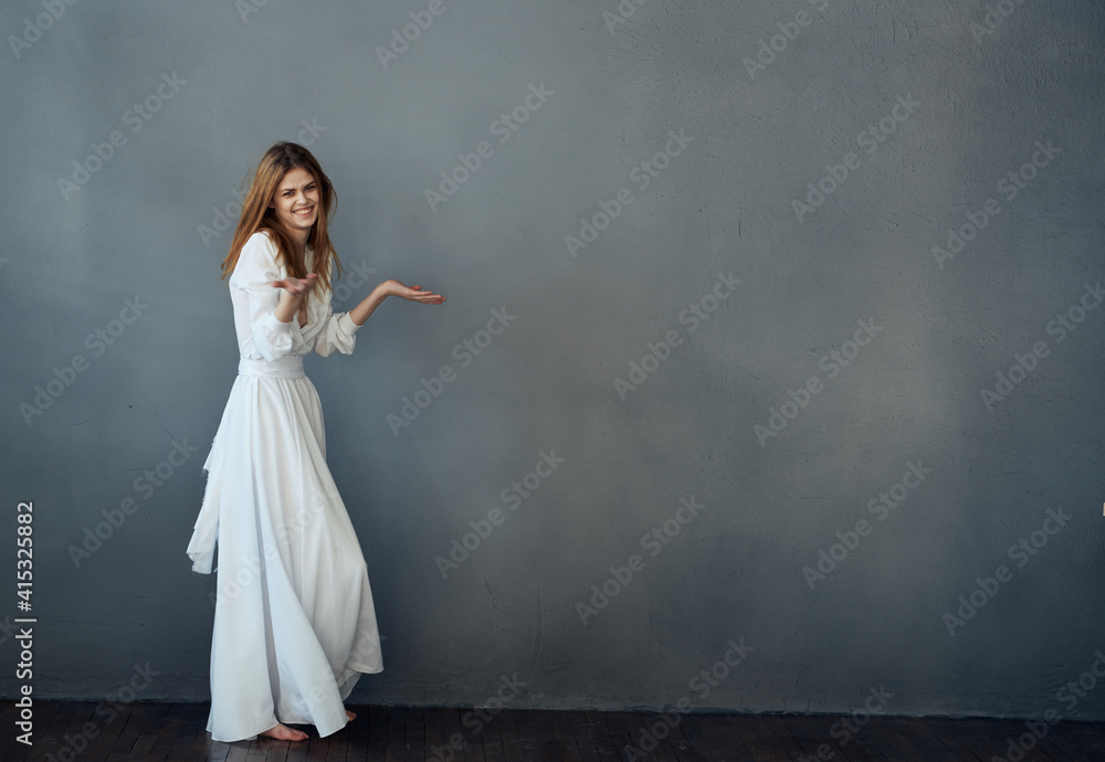 Woman in white dress glamor dance gray background