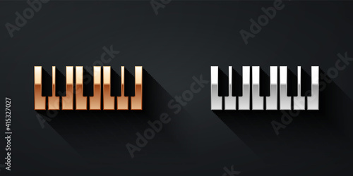 Gold and silver Music synthesizer icon isolated on black background. Electronic piano. Long shadow style. Vector.