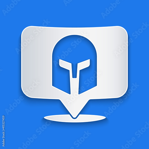 Paper cut Greek helmet icon isolated on blue background. Antiques helmet for head protection soldiers with a crest of feathers or horsehair. Paper art style. Vector.