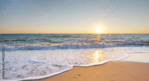 Sandy seashore at sunset.