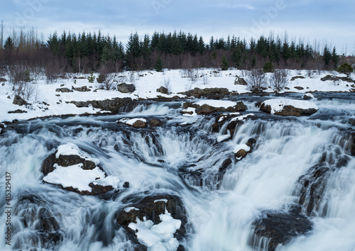 The valley of Elliðaárdalur waterfall and Elliðaá river landscape in winter time . Reykjavik nature
