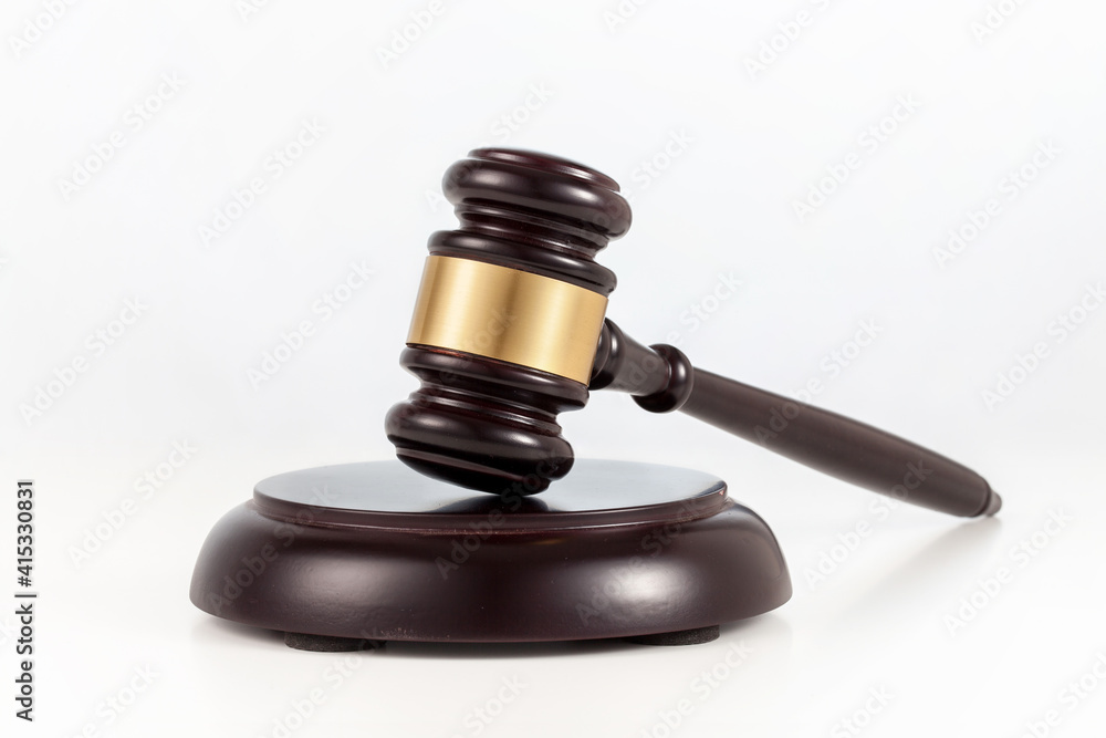 a wooden judge gavel and soundboard on white background. a wooden judge gavel and soundboard on white background.