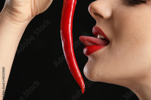 Sexy young woman with chili...