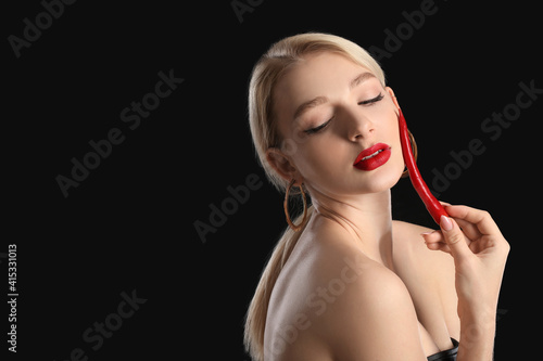 Sexy young woman with chili...