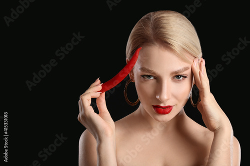 Sexy young woman with chili...
