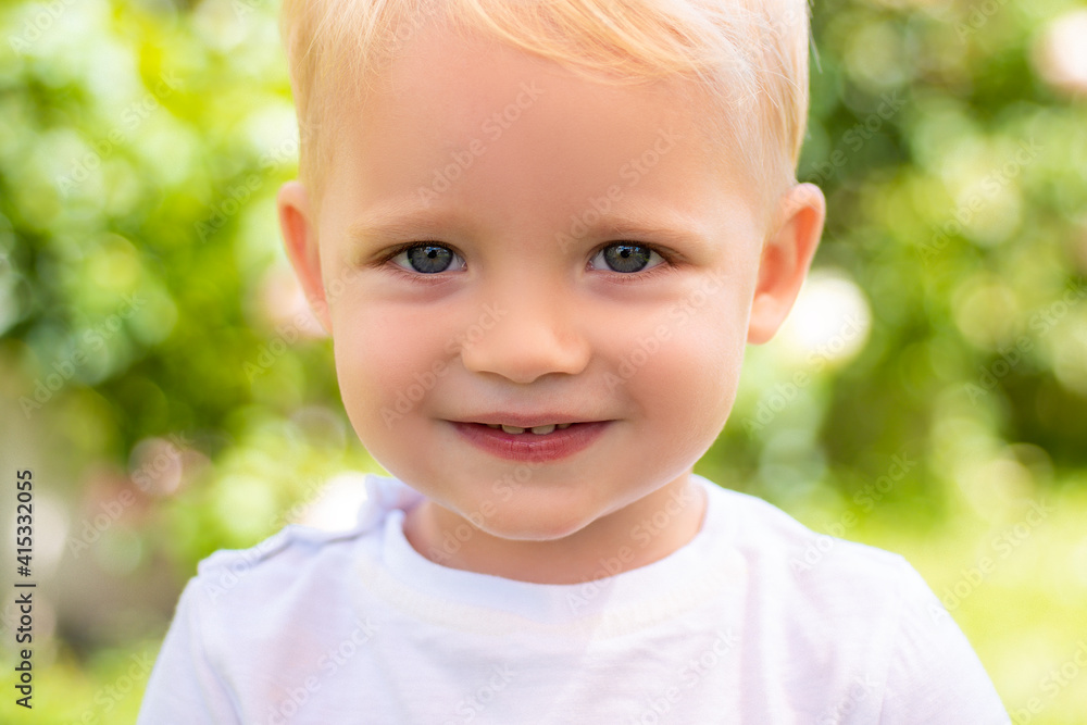 Closeup smile kid face. Cortrait of smiling child boy on outdoor background. Closeup smile kid face. Cortrait of smiling child boy on outdoor background.