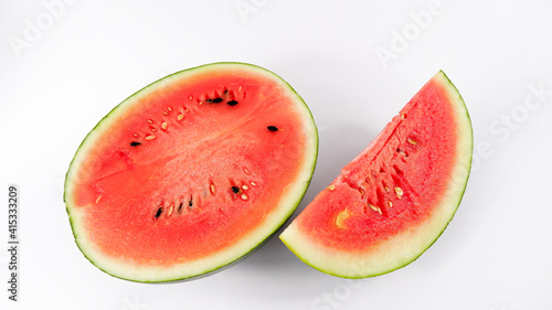 Watermelon cut in half, red with black mead