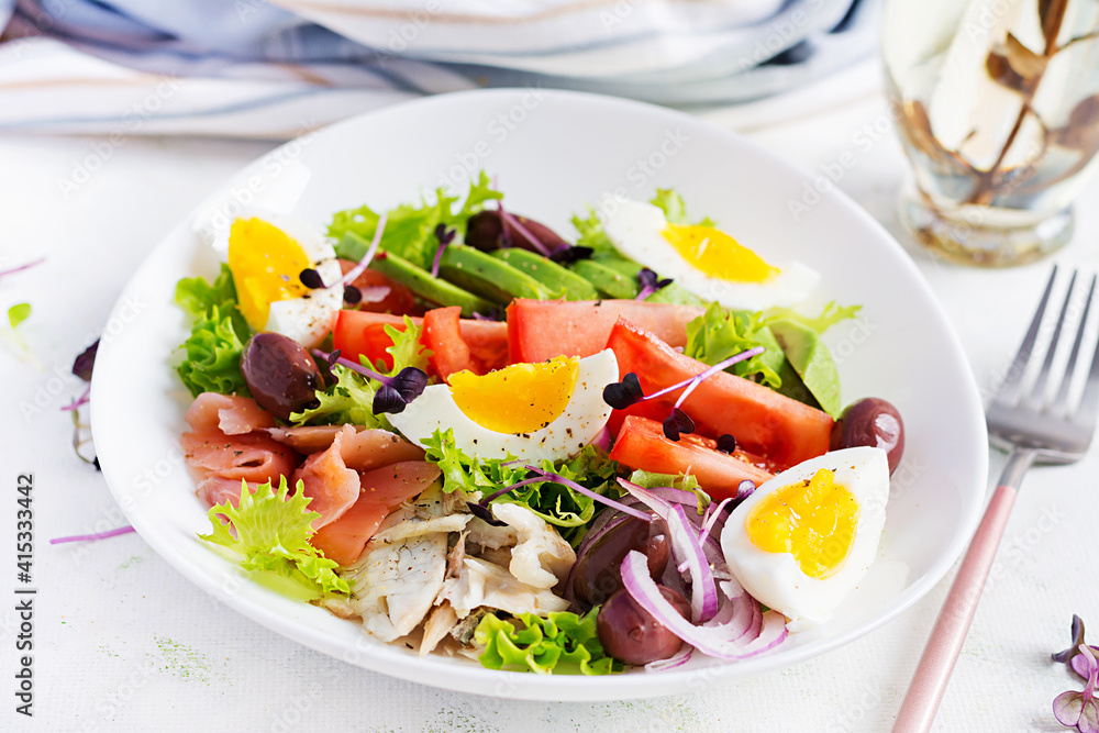 Ketogenic diet breakfast. Salt salmon and baked dorado salad with greens, tomatoes, eggs and avocado. Zero waste, eco friendly concept. Ketogenic diet breakfast. Salt salmon and baked dorado salad with greens, tomatoes, eggs and avocado. Zero waste, eco friendly concept.