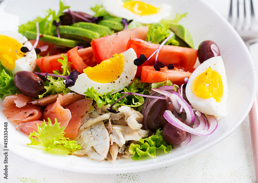 Ketogenic diet breakfast. Salt salmon and baked dorado salad with greens, tomatoes, eggs and avocado. Zero waste, eco friendly concept. Ketogenic diet breakfast. Salt salmon and baked dorado salad with greens, tomatoes, eggs and avocado. Zero waste, eco friendly concept.