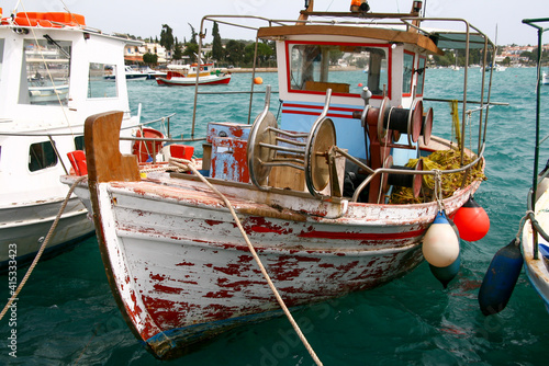 old traditional wooden fishing boats in the harbor of Porto cheli