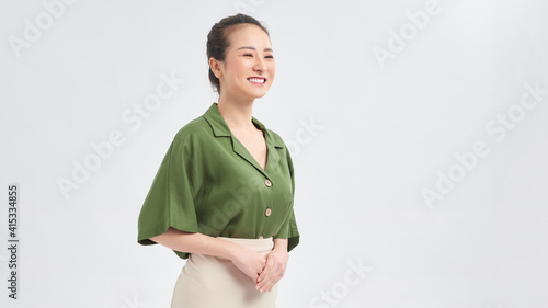 фотографія Portrait of emotive good-looking asian woman laughing while looking aside and standing against white background