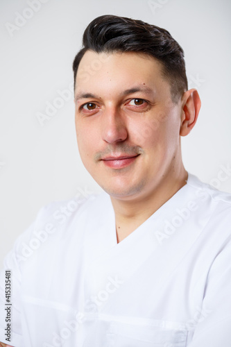 Young male doctor in a white surgical suit.Isolated on a white background