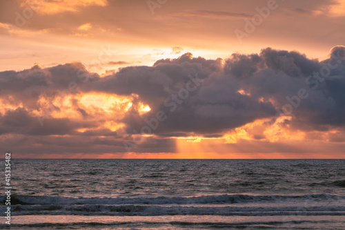 Sunset on the ocean with sun rays, French coast line. 