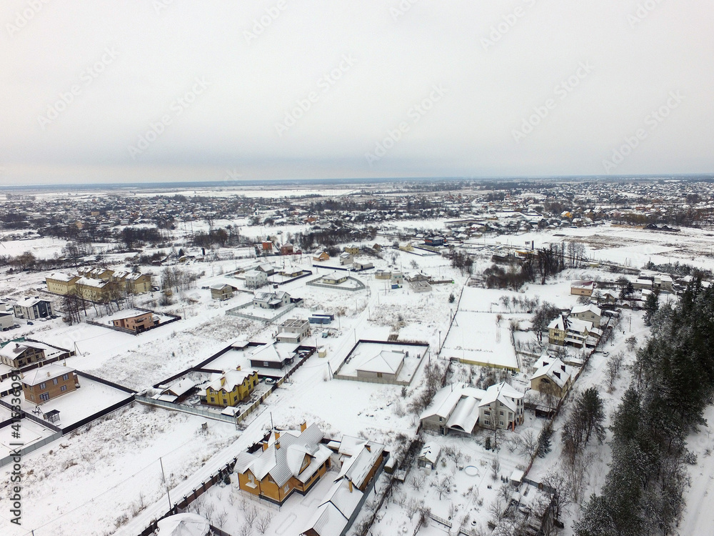 Aerial view of the countryside with the snow at winter time (drone image). Saburb of Kiev,Ukraine