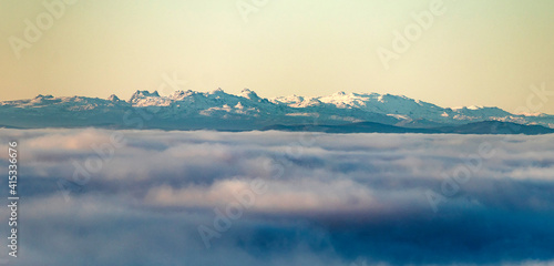 Full view of the snowy Sierra de Xurés-Geres above a sea of ​​clouds photo