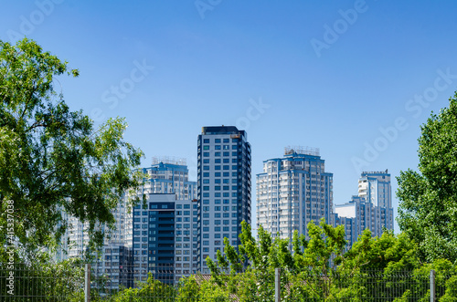 Modern residential apartment with flat buildings exterior. Detail of New luxury house and home complex. Part of City Real estate property and condo architecture. Blue sky © corvalola