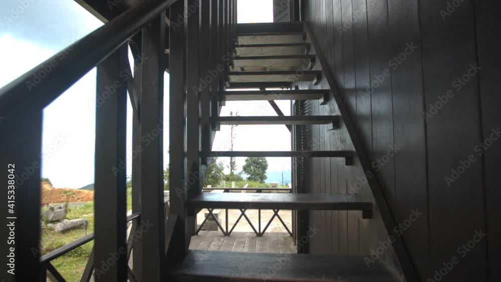 Camera moves upstairs from wooden terrace to balcony of Yersin house on peak of Hon-Ba mountain in Vietnam Camera moves upstairs from wooden terrace to balcony of Yersin house on peak of Hon-Ba mountain in Vietnam