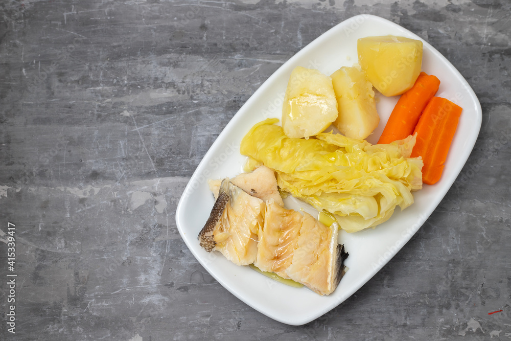 boiled cod fish with boiled vegetables and egg on white dish boiled cod fish with boiled vegetables and egg on white dish