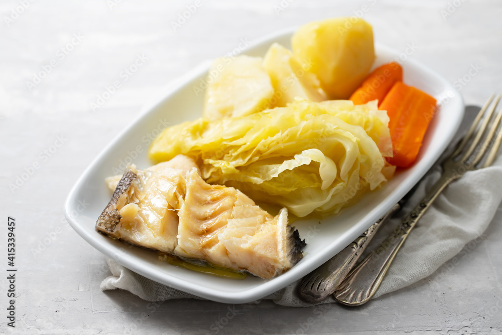 boiled cod fish with boiled vegetables and egg on white dish boiled cod fish with boiled vegetables and egg on white dish