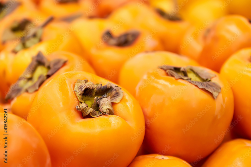 Ripe orange Persimmon in Grocery store. Close-up, selective focus Ripe orange Persimmon in Grocery store. Close-up, selective focus