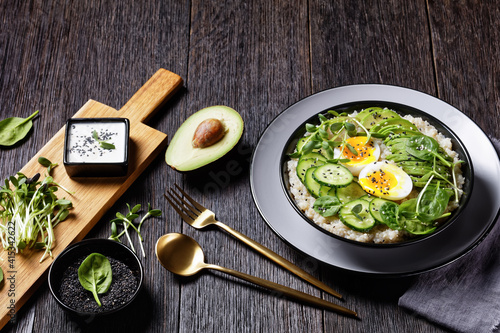 quinoa bowl with greens, avocado and boiled egg