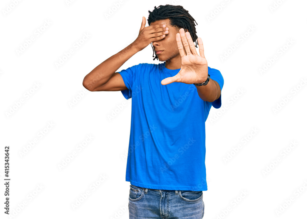 Young african american man wearing casual clothes covering eyes with hands and doing stop gesture with sad and fear expression. embarrassed and negative concept.
