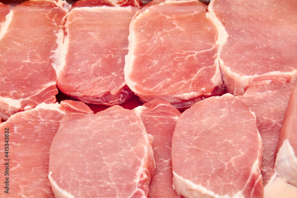 Fresh Pork steaks in a shop window. Close-up, selective focus Fresh Pork steaks in a shop window. Close-up, selective focus