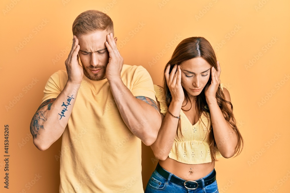 Young couple of girlfriend and boyfriend hugging and standing together with hand on head, headache because stress. suffering migraine. Young couple of girlfriend and boyfriend hugging and standing together with hand on head, headache because stress. suffering migraine.