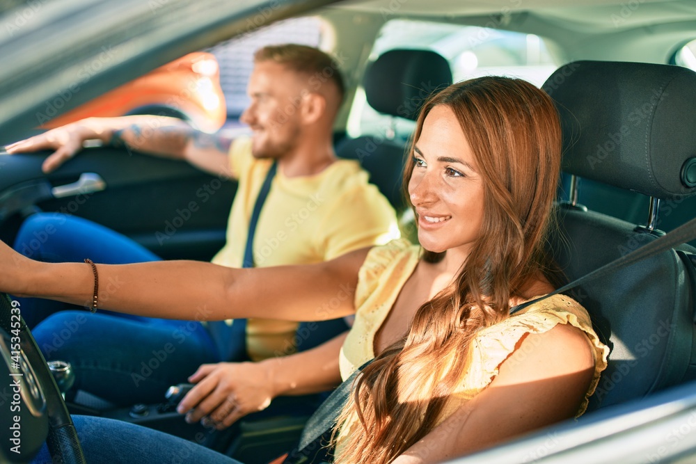 Young couple smiling happy driving car, Young couple smiling happy driving car,