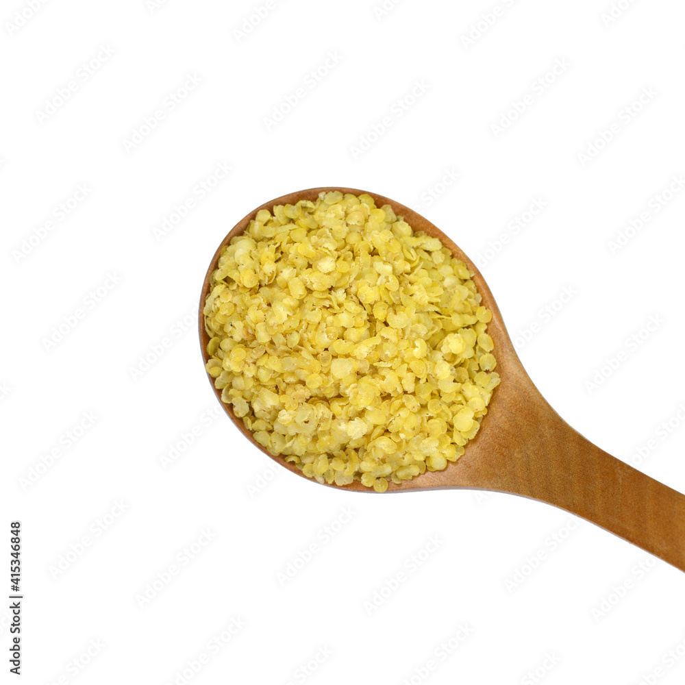 Millet flakes in a wooden spoon isolated on white bacground. Millet flakes in a wooden spoon isolated on white bacground.