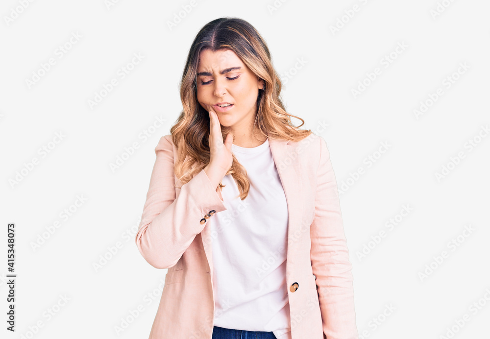 Young caucasian woman wearing business clothes touching mouth with hand with painful expression because of toothache or dental illness on teeth. dentist Young caucasian woman wearing business clothes touching mouth with hand with painful expression because of toothache or dental illness on teeth. dentist