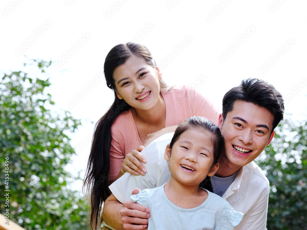 Happy family of three in the outdoor group photo Happy family of three in the outdoor group photo