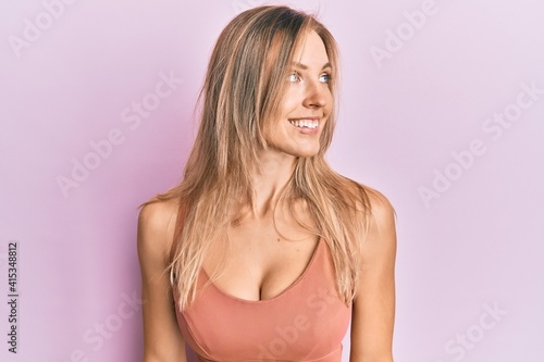 Beautiful caucasian woman wearing casual clothes looking to side, relax profile pose with natural face and confident smile.