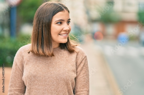 Wallpaper Mural Young hispanic woman smiling happy standing at the city. Torontodigital.ca